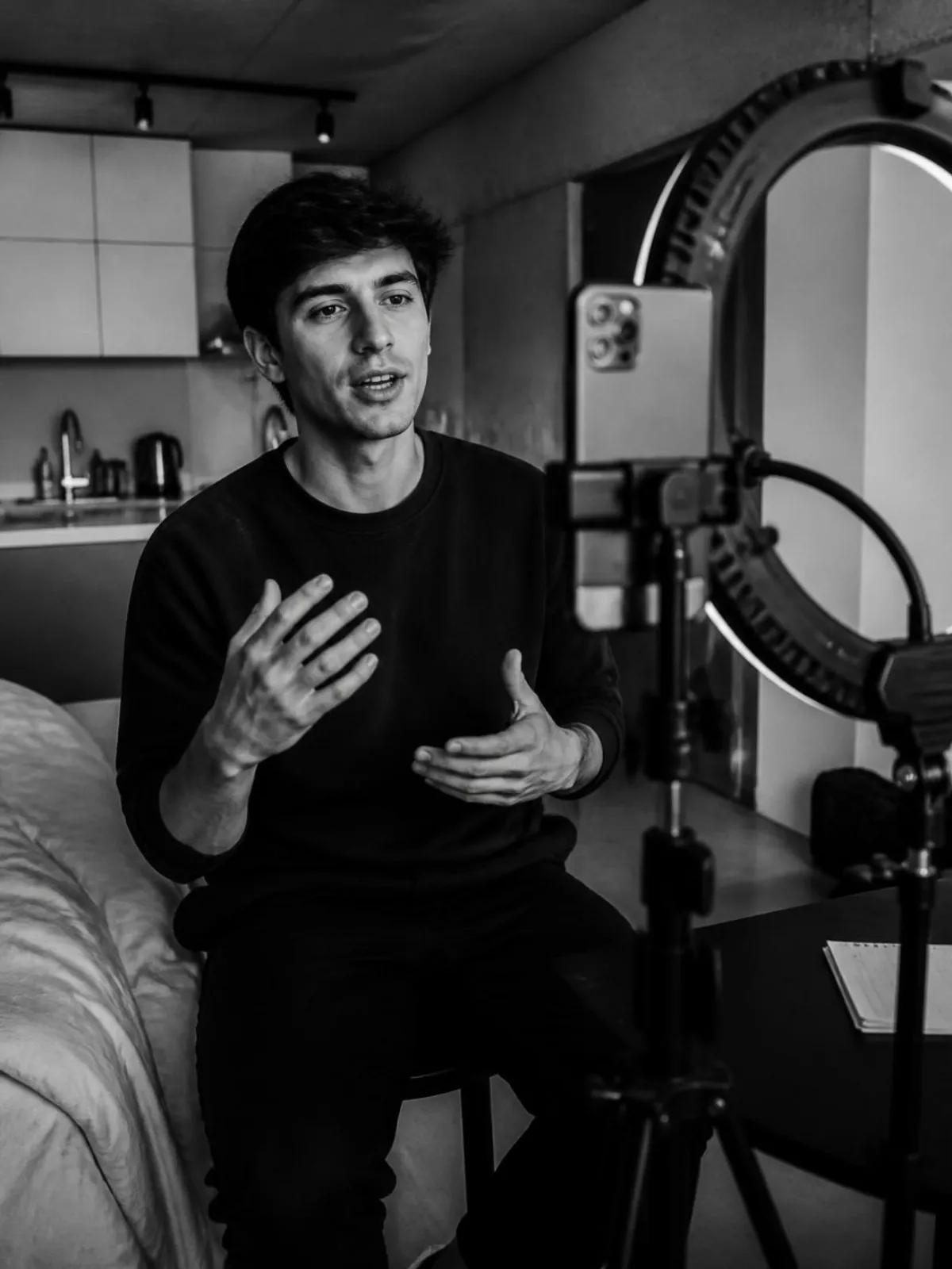 Creator filming a video with a phone and ring light